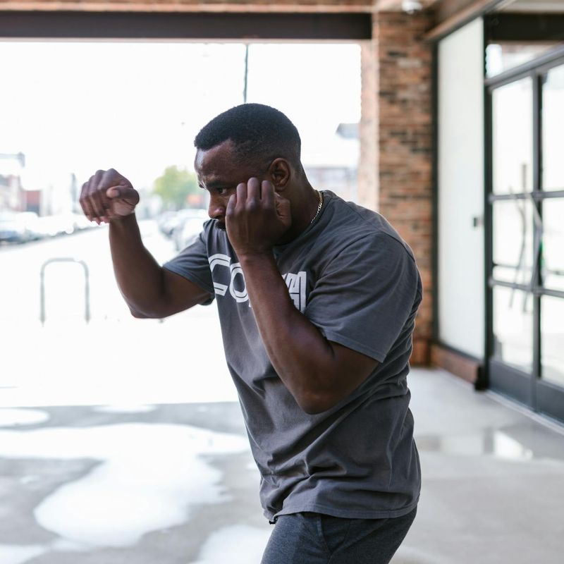 Man in a focused stance preparing for a bodyweight exercise.